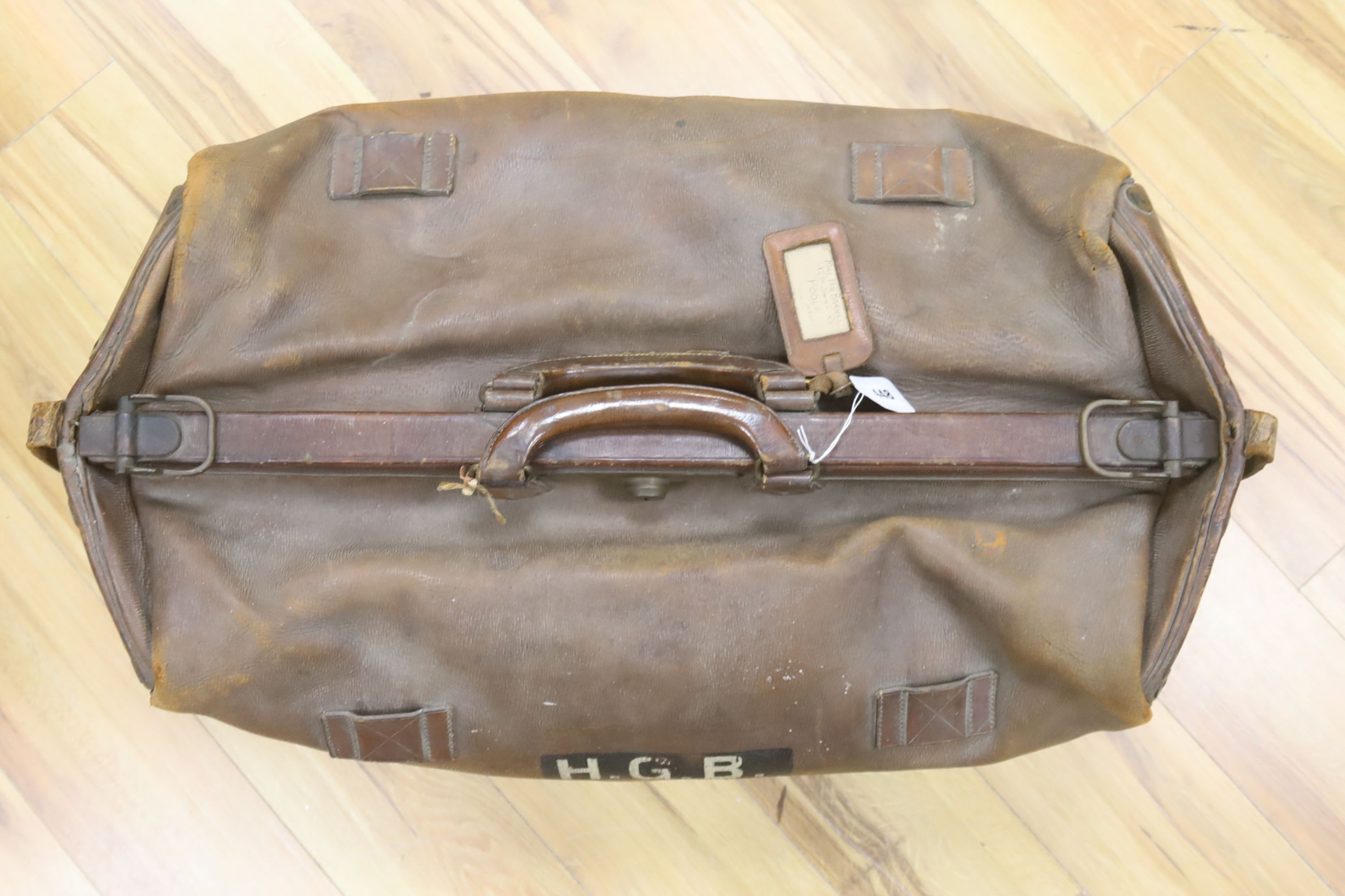 A large Gladstone bag, military canvas contents